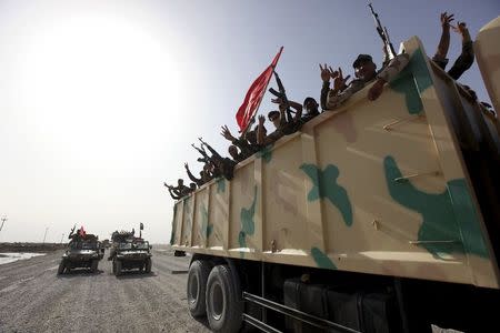 Shi'ite paramilitaries riding military vehicles travel from Lake Tharthar toward Ramadi to fight against Islamic state militants, west of Samarra, Iraq May 27, 2015. REUTERS/Stringer