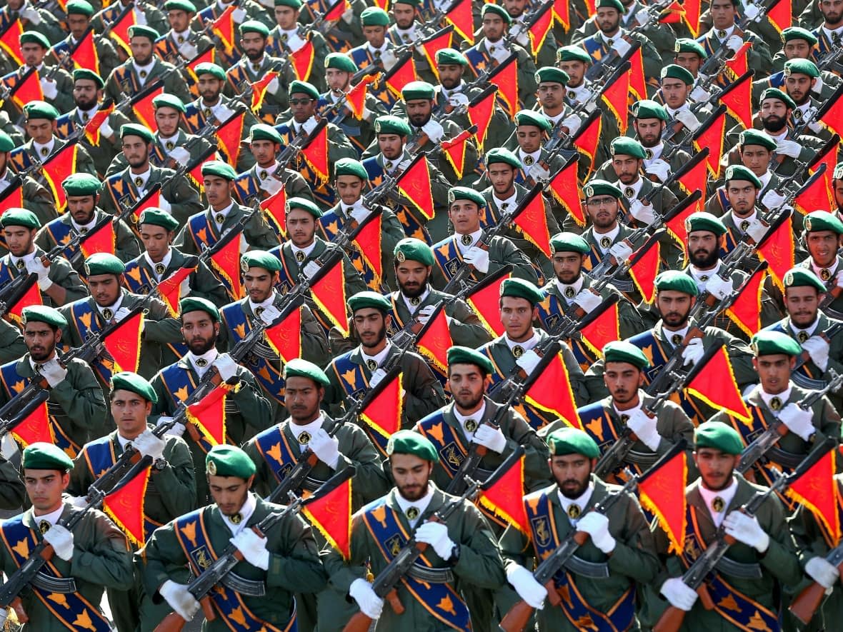 Iran's Revolutionary Guard troops march in a military parade in a 2016 file photo in Tehran. Canada has imposed sanctions on 139 individuals since the IRGC's crackdown on Iranian protesters began last fall.  (Ebrahim Noroozi/Associated Press - image credit)