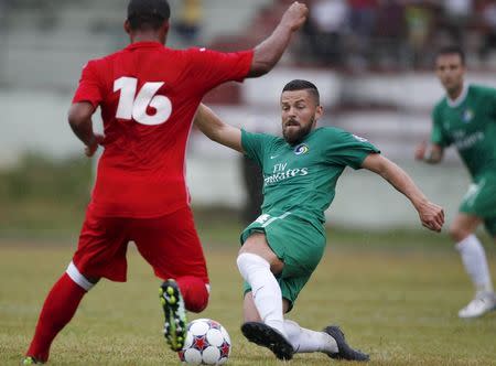 New York Cosmos player Danny Sztela (R) and Cuba's Hanier Dranguet fight for the ball during a friendly game in Havana June 2, 2015. REUTERS/Enrique de la Osa