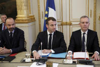 French President Emmanuel Macron, center, French Prime Minister Edouard Philipppe, left, and Environment Minister Francois de Rugy meet with representatives of trade unions, employers' organizations and local elected officials at the Elysee Palace in Paris, Monday, Dec.10 2018. Macron is preparing to speak to the nation Monday at last, after increasingly violent and radicalized protests against his leadership and a long silence that aggravated the anger. (Yoan Valat, Pool via AP)