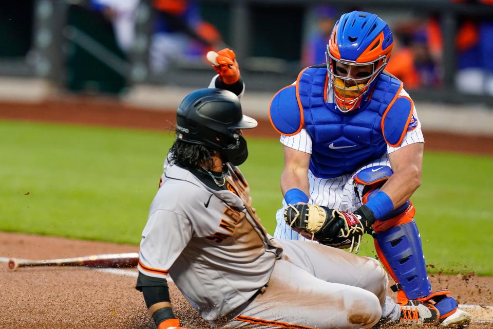 New York Mets catcher James McCann, right, tags out San Francisco Giants' Brandon Crawford at home plate during the first inning of a baseball game Wednesday, April 20, 2022, in New York. (AP Photo/Frank Franklin II)