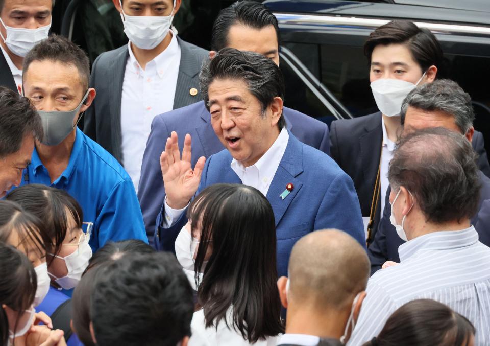 This picture taken on 6 July 2022 shows former Japanese prime minister Shinzo Abe (C) meeting with supporters after he delivered a campaign speech for the ruling Liberal Democratic Party (AFP via Getty Images)