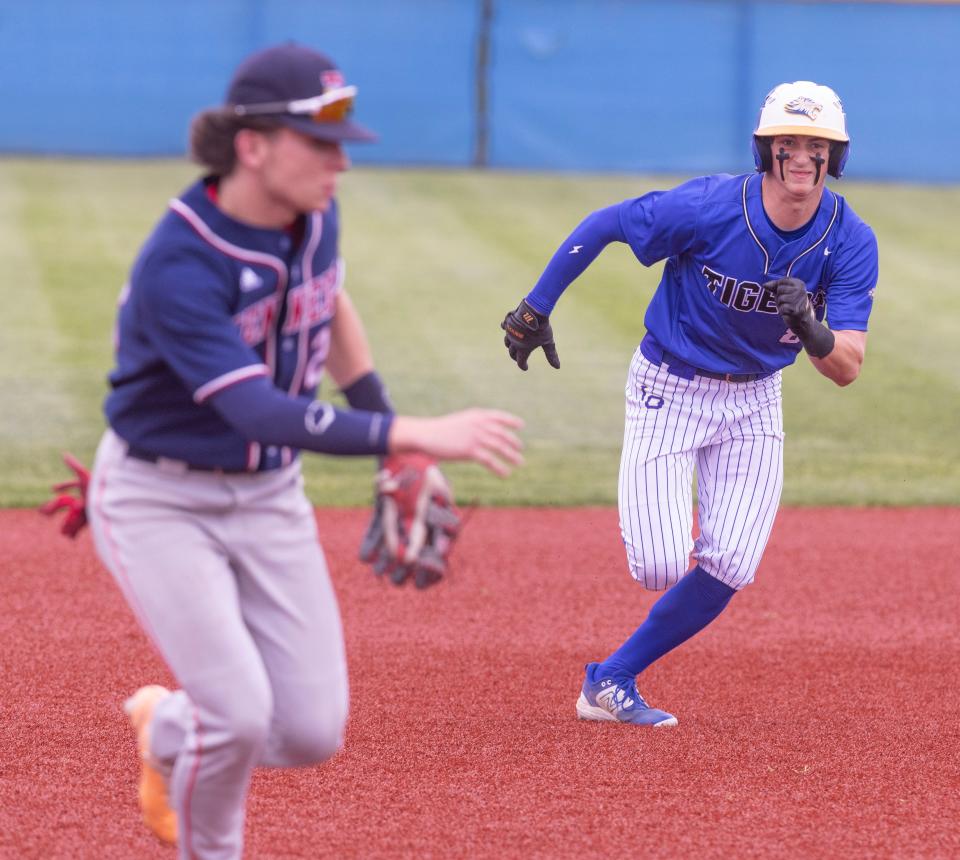 Lake Center Christian's Harrison Coblentz rounds second and heads for third safely against Warren JFK at Lake Center Christian Monday, May 6, 2024.