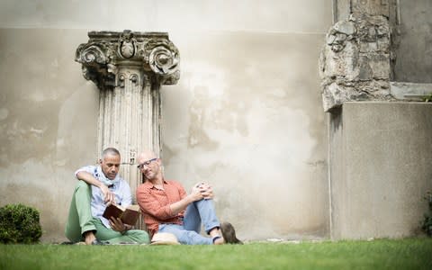 Gay couple reclining against a wall in Paris - Credit: Getty