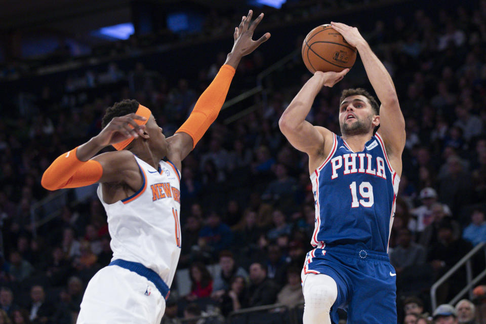 Philadelphia 76ers guard Raul Neto (19) shoots a three-point basket past New York Knicks guard Frank Ntilikina (11) in the first half of an NBA basketball game, Saturday, Jan. 18, 2020, at Madison Square Garden in New York. (AP Photo/Mary Altaffer)