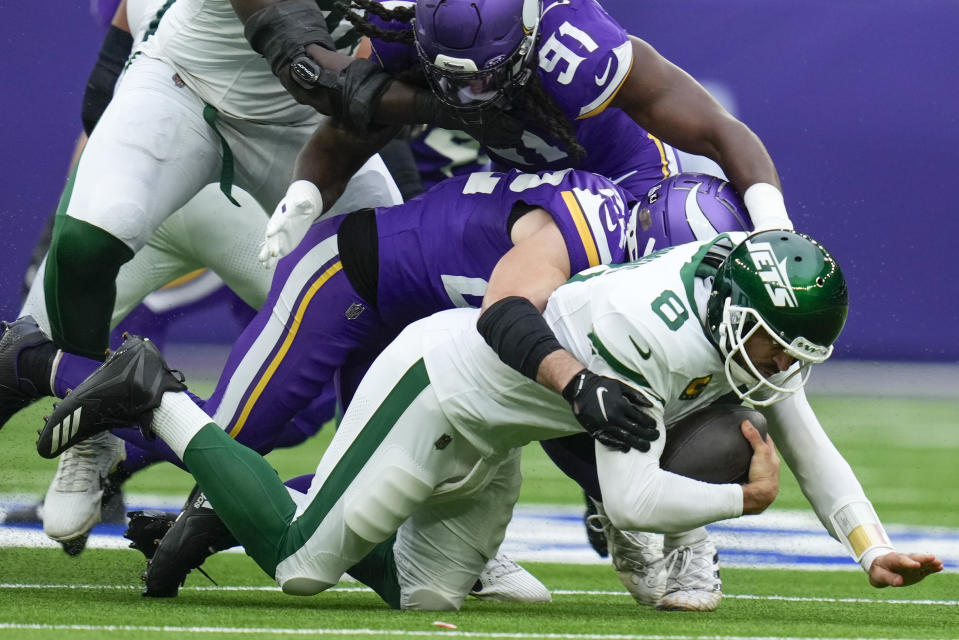 New York Jets quarterback Aaron Rodgers, bottom, is sacked by Minnesota Vikings' Harrison Smith during the first half of an NFL football game, Sunday, Oct. 6, 2024, at the Tottenham Hotspur stadium in London. (AP Photo/Kirsty Wigglesworth)