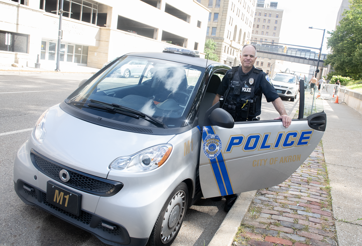 Lt. Jay Strainer in his Akron Police Department smart car on Friday, July 19.