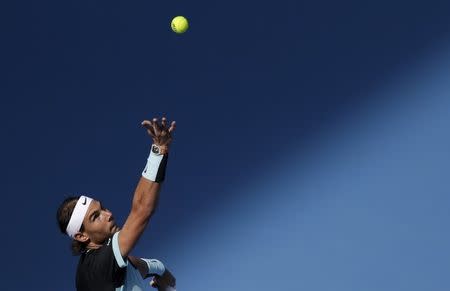 Rafa Nadal of Spain serves a ball against Fabio Fognini of Italy during their men's singles semifinal match at the China Open tennis tournament in Beijing, China, October 10, 2015. REUTERS/Jason Lee