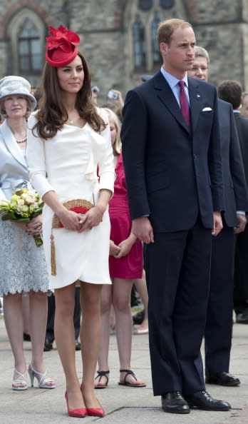 <div class="caption-credit"> Photo by: Getty Images</div><div class="caption-title">The Duchess in Reiss at at the Canadian Museum of Civilization, July 2011</div>You may remember this white dress from Middleton's famous engagement photo! The Reiss "Nannette" dress was from 2010, but the company reissued it last year for $310 due to popular demand. (Catherine also wore Reiss when she met Barack and Michelle Obama.) Her red hat is by milliner Sylvia Fletcher at Lock & Co. and her cute fan bag was made by British accessory designer Anya Hindmarch.