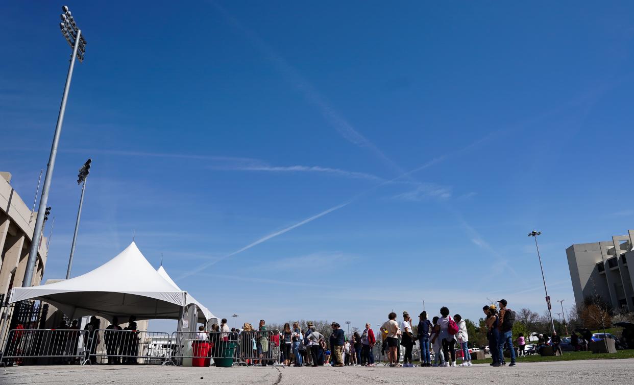 Attendees wait for the gates to open at Memorial Stadium for the Hoosier Cosmic Celebration on Monday, April 8, 2024.