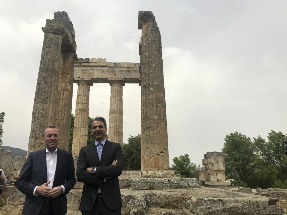 European People's Party candidate Manfred Weber, left, and the leader of Greece's conservative New Democracy party Kyriakos Mitsotakis visit an ancient temple at Nemea about 117 kilometers (73 miles) west of Athens on Tuesday, April 23, 2019. Weber is in Greece for the official launch of his campaign for the May 23-26 European Parliament elections. (AP Photo/Derek Gatopoulos)