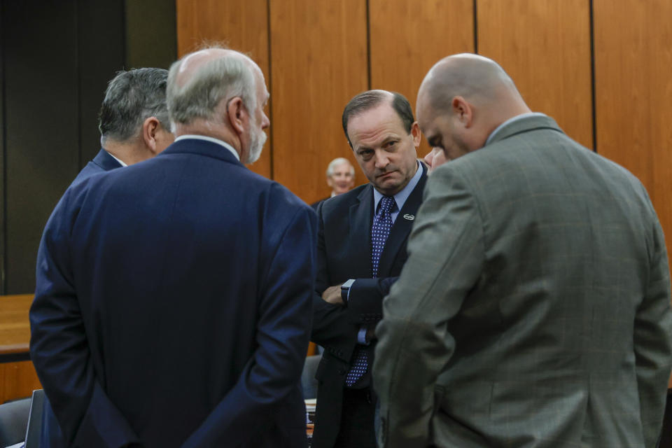 South Carolina Attorney General Alan Wilson, facing, speaks with members of his staff during a break in a hearing on a motion for Alex Murdaugh's retrial, Tuesday, Jan. 16, 2024, at the Richland County Judicial Center in Columbia, S.C. Murdaugh was convicted of killing his wife, Maggie, and younger son, Paul, in June 2021. (Tracy Glantz/The State via AP, Pool)