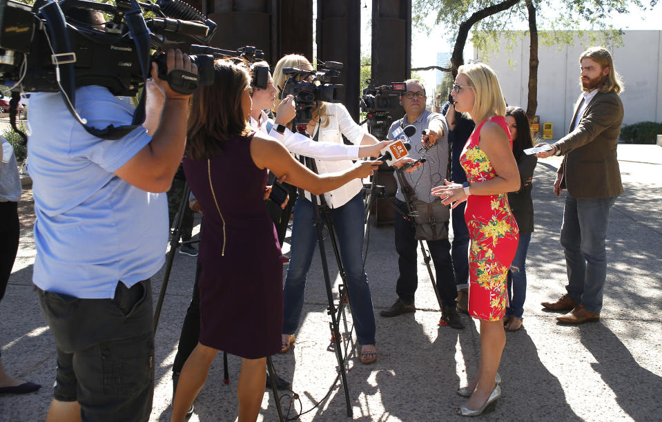 U.S. Senate candidate Kyrsten Sinema, D-Ariz., speaks with the media at the Barton Barr Central Library, Tuesday, Nov. 6, 2018 in Phoenix. Sinema and Republican challenger Martha McSally are seeking the senate seat being vacated by Jeff Flake, R-Ariz., who is retiring in January.(AP Photo/Rick Scuteri)