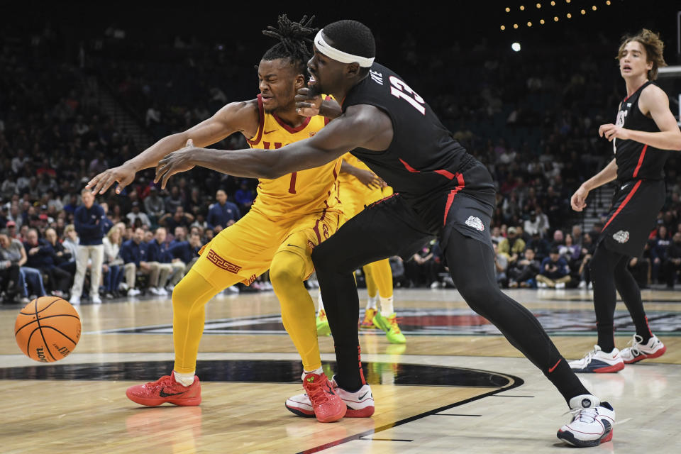 Southern California guard Isaiah Collier (1) and Gonzaga forward Graham Ike (13) reach for the ball during the second half of an NCAA college basketball game Saturday, Dec. 2, 2023, in Las Vegas. (AP Photo/Sam Morris)