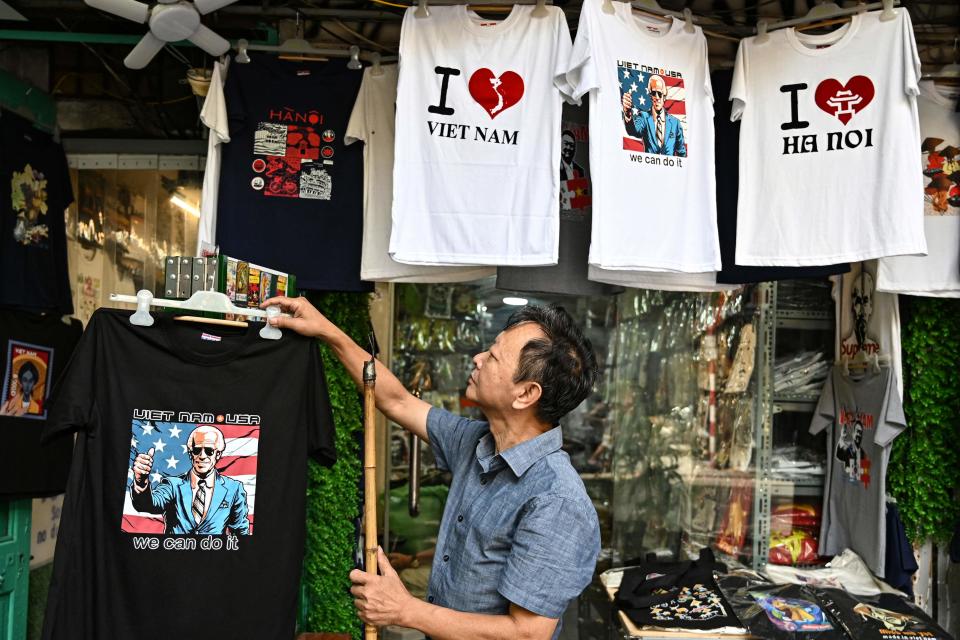 Vietnamese designer Truong Thanh Duc displays a shirt with an image of U.S. President Joe Biden at his souvenir shop in Hanoi on Sept. 6, 2023. Biden is scheduled to visit the capital city on Sept. 10.