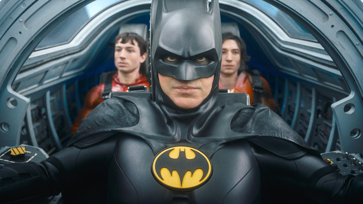  (L-R) Ezra Miller as The Flash, Michael Keaton as Batman and Ezra Miller as The Flash in The Flash, inside a cockpit 