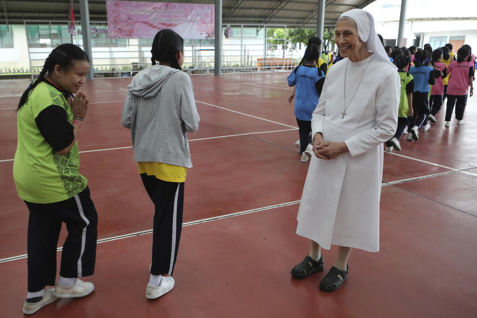 In this Aug. 27, 2019, photo, Thai students give a Thai traditional greeting gesture of "wai" to ST. Mary's School Vice Principal Sister Ana Rosa Sivori, right, as they go back to classroom at the girls' school in Udon Thani, about 570 kilometers (355 miles) northeast of Bangkok, Thailand. Sister Ana Rosa Sivori, originally from Buenos Aires in Argentina, shares a great-grandfather with Jorge Mario Bergoglio, who, six years ago, became Pope Francis. So, she and the pontiff are second cousins. (AP Photo/Sakchai Lalit)