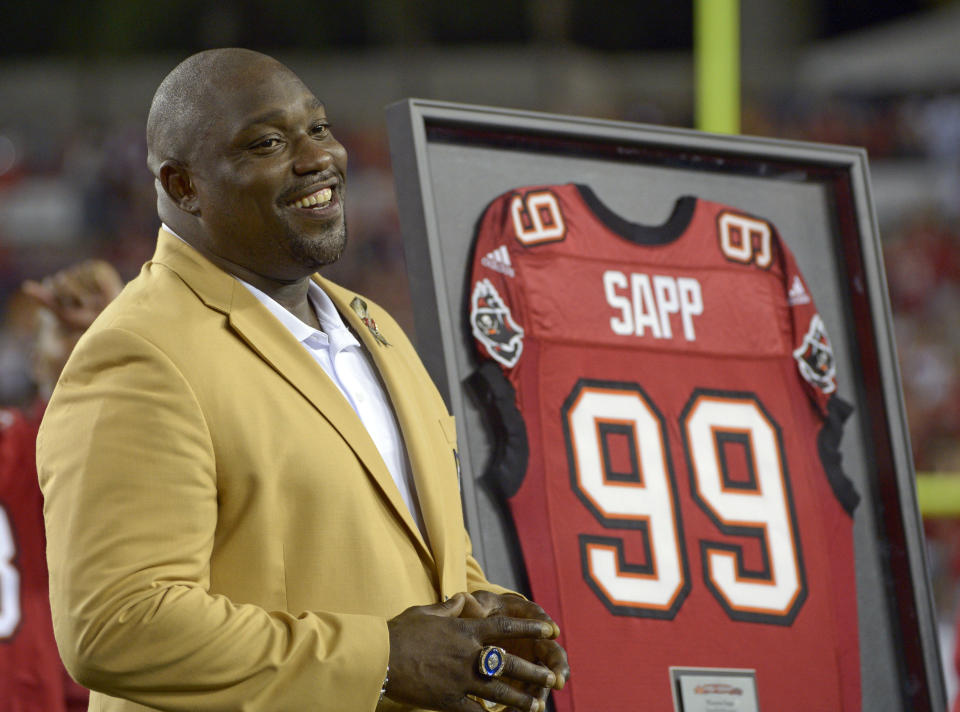 FILE - In this Nov. 11, 2013, file photo, former Tampa Bay Buccaneers player Warren Sapp smiles after being inducted in the Ring of Honor ceremony during halftime in an NFL football game between the Tampa Bay Buccaneers and the Miami Dolphins in Tampa, Fla. Hall of Famer Warren Sapp wishes the Buccaneers could pack the stands for the first Super Bowl played in a host team’s home stadium. (AP Photo/Phelan M. Ebenhack, File)