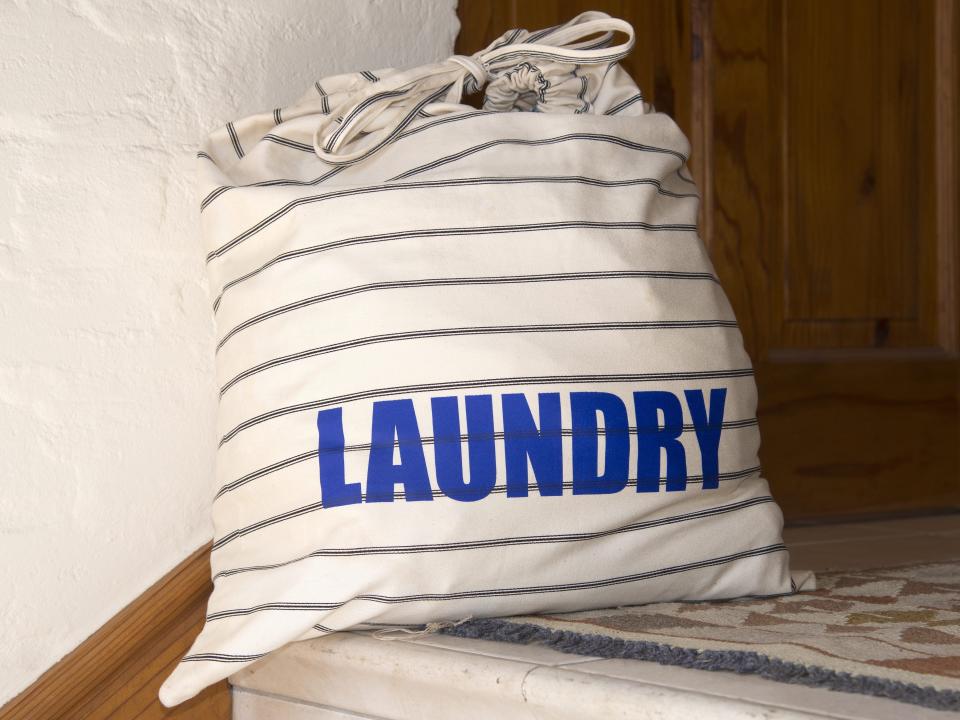 Black and white striped laundry bag at top of staircase