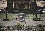 <p>Debris is strewn through the scene of a mass shooting at a music festival near the Mandalay Bay resort and casino on the Las Vegas Strip, Monday, Oct. 2, 2017, in Las Vegas. (Photo: John Locher/AP) </p>