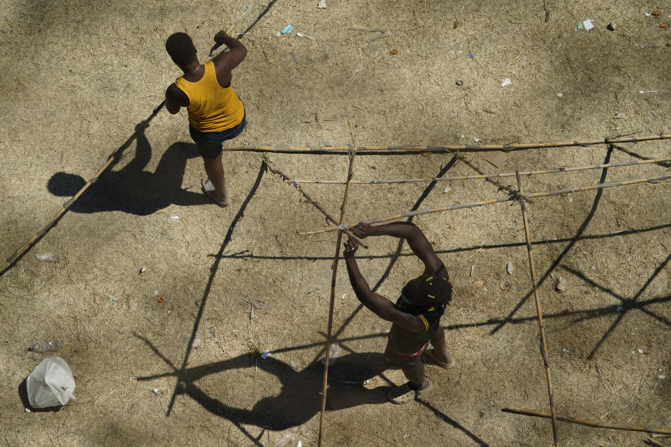 Haitian migrants use carrizo cane to build a shelter along the Rio Grande after crossing into the United States from Mexico, Friday, Sept. 17, 2021, in Del Rio, Texas. Thousands of Haitian migrants have assembled under and around a bridge in Del Rio presenting the Biden administration with a fresh and immediate challenge as it tries to manage large numbers of asylum-seekers who have been reaching U.S. soil. (AP Photo/Eric Gay)