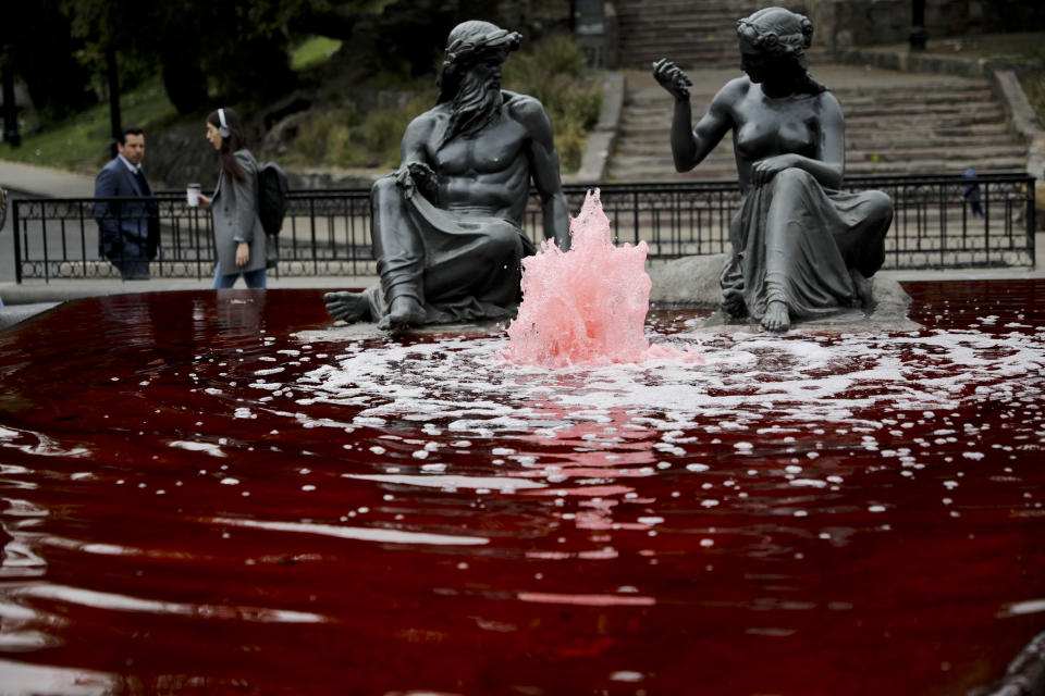 Water sprout from a fountain dyed red by anti-government protesters in Santiago, Chile, Tuesday, Oct. 29, 2019. Chileans gathered Tuesday for a 12th day of demonstrations that began with youth protests over a subway fare hike and have become a national movement demanding greater socio-economic equality and better public services in a country long seen as an economic success story. (AP Photo/Rodrigo Abd)