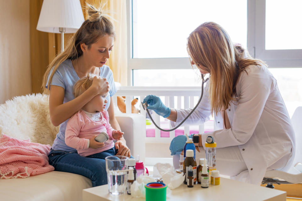 Home health nurse showing her stethoscope to a pediatric patient