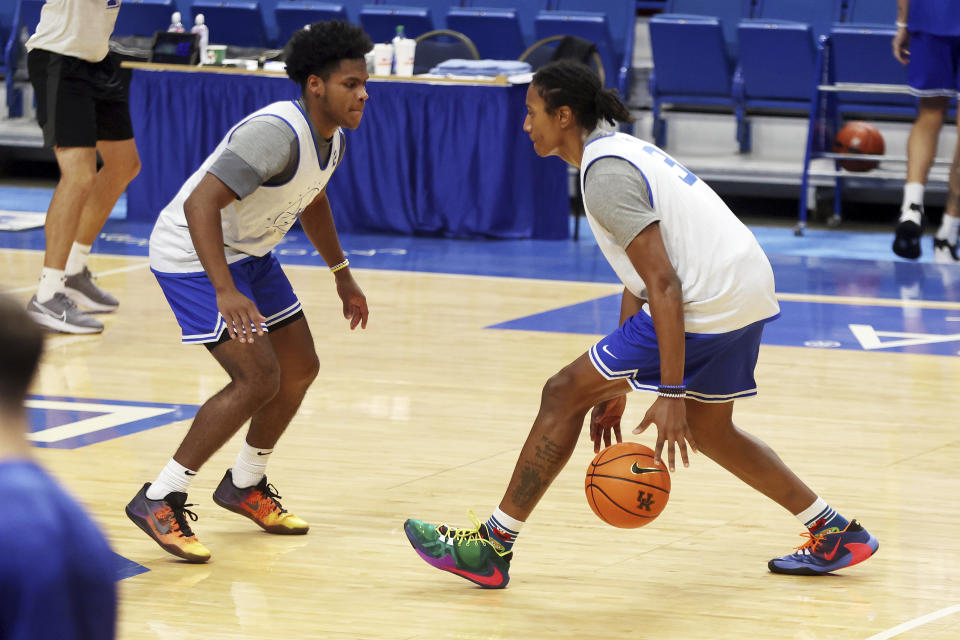 Kentucky's Tyty Washington Jr., right, drives against teammate Sahvir Wheeler during an NCAA college basketball open house practice in Lexington, Ky., Monday, Oct. 11, 2021. (AP Photo/James Crisp)