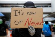 A demonstrator holds a placard during a protest in Hong Kong