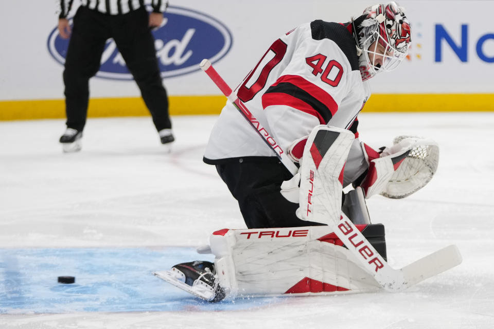 A puck shot by New York Islanders' Brock Nelson gets past New Jersey Devils goaltender Akira Schmid (40) for a goal during the second period of an NHL hockey game Friday, Oct. 20, 2023, in Elmont, N.Y. (AP Photo/Frank Franklin II)