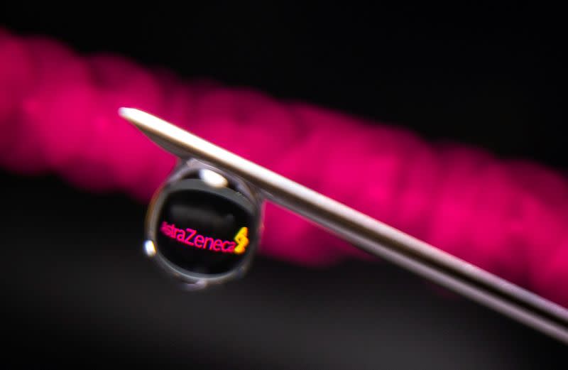 FILE PHOTO: AstraZeneca logo is reflected in a drop on a syringe needle in this illustration photo