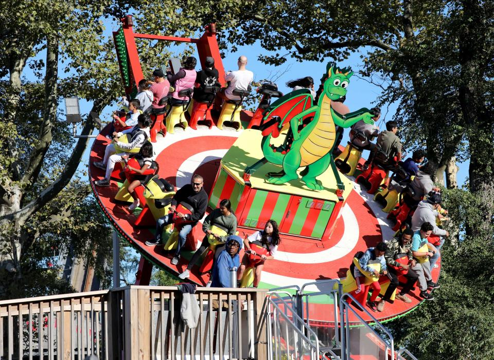 Park goers ride the Dragonator at Playland Amusement Park in Rye, on the last weekend of the season, Sept. 24, 2022. 