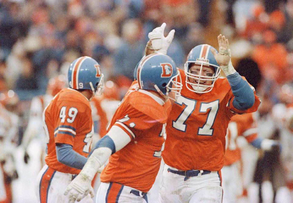 Denver Broncos linebacker Karl Mecklenburg (77) celebrates with teammates in Denver, Colo., Nov. 16, 1986.