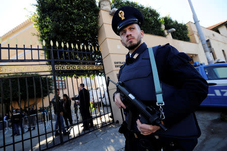 A policeman stands guard outside Villa Igiea, the venue of the international conference on Libya, in Palermo, Italy, November 12, 2018. REUTERS/Guglielmo Mangiapane