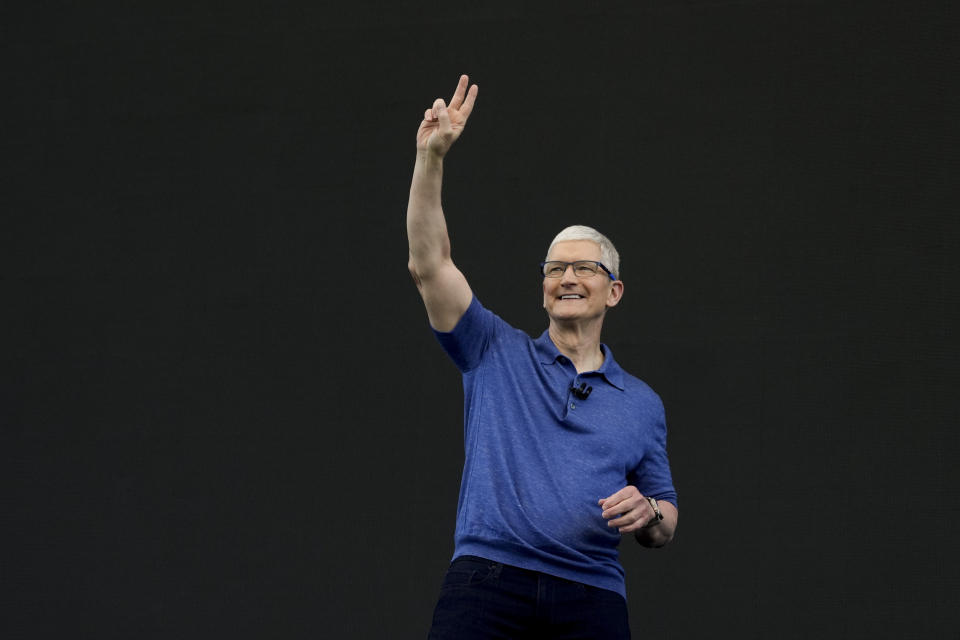 Apple CEO Tim Cook waves while speaking at an announcement of new products on the Apple campus in Cupertino, Calif., Monday, June 10, 2024. (AP Photo/Jeff Chiu)