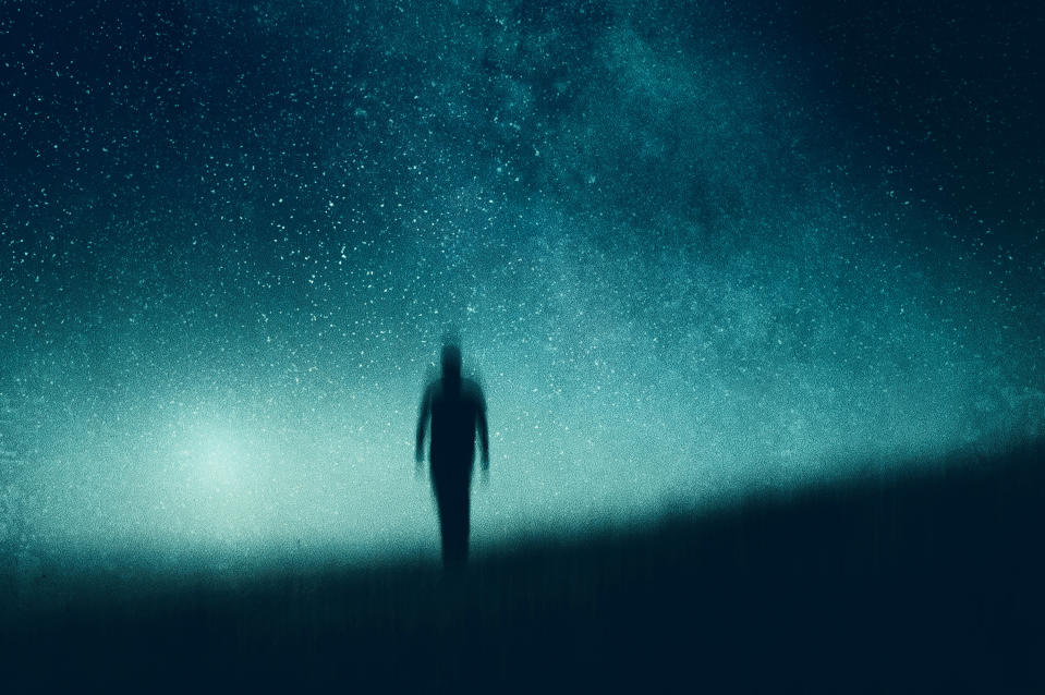 Silhouette of someone walking with stars in the background