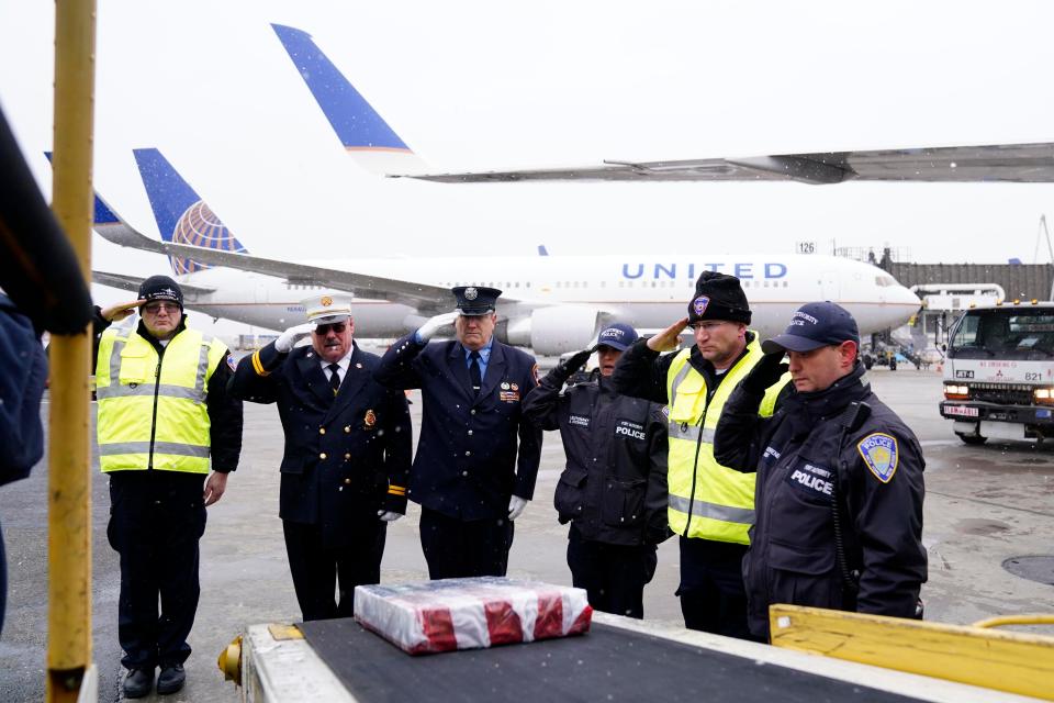 Members of the Port Authority Fire Department (PAFD) and Port Authority Police Department salute the World Trade Center steel, wrapped in an American flag, as it's loaded onto a United Airlines plane heading for London at Newark Liberty International Airport on Tuesday, March 14, 2023. United Airlines, in partnership with the PAFD, transports a piece of the World Trade Center steel to Basildon, England where it will become a part of their September 11 memorial.