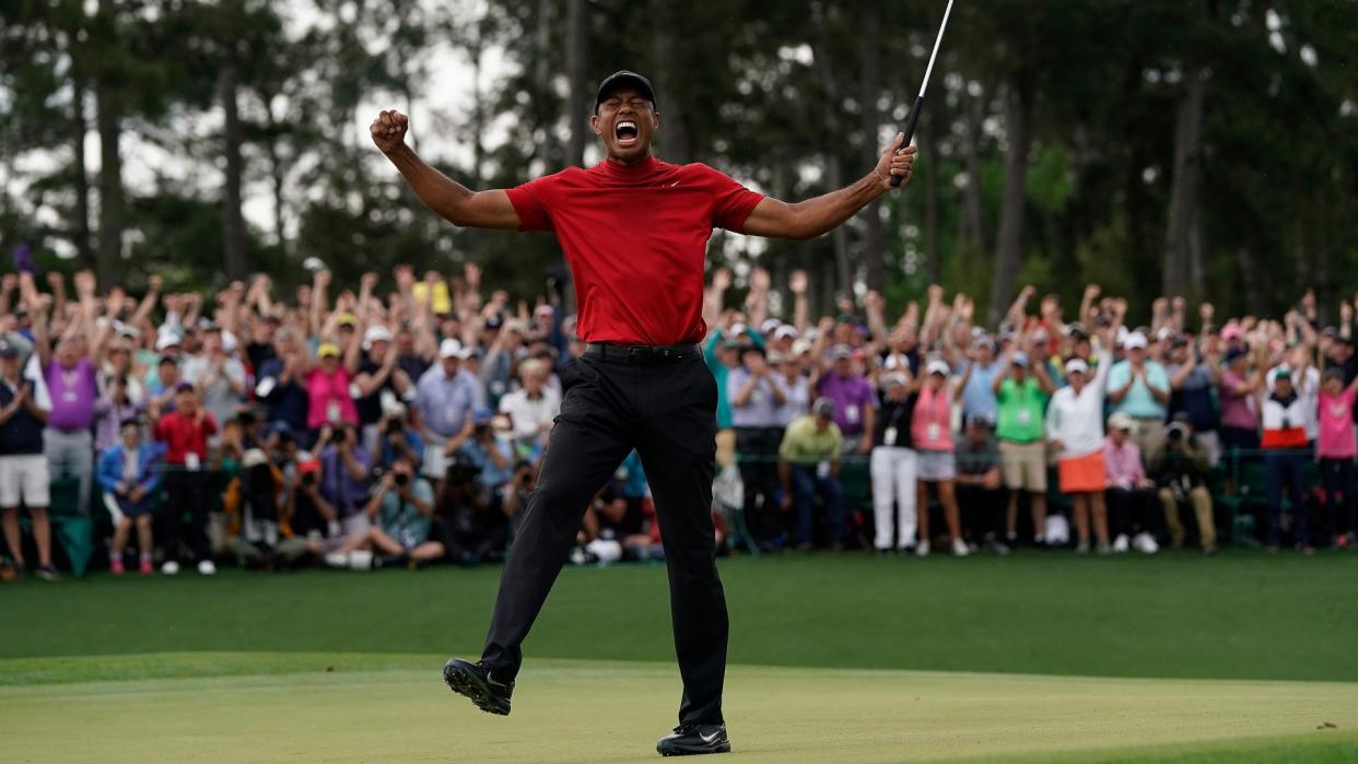 Mandatory Credit: Photo by David J Phillip/AP/Shutterstock (10582244a)Tiger Woods reacts as he wins the Masters golf tournament in Augusta, Ga.