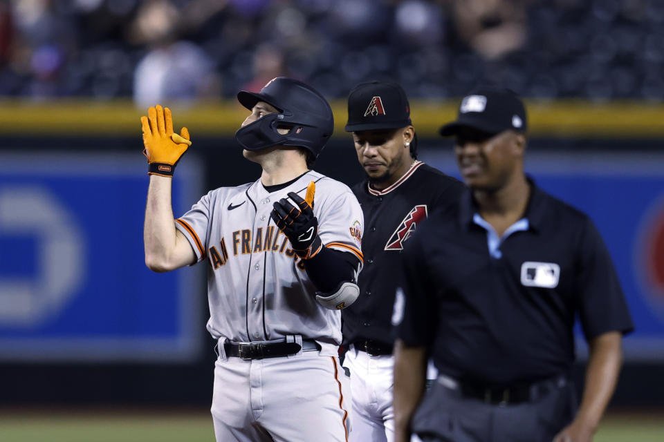 San Francisco Giants' Casey Schmitt reacts after hitting an RBI double during the ninth inning of the team's baseball game against the Arizona Diamondbacks on Thursday, May 11, 2023, in Phoenix. (AP Photo/Chris Coduto)