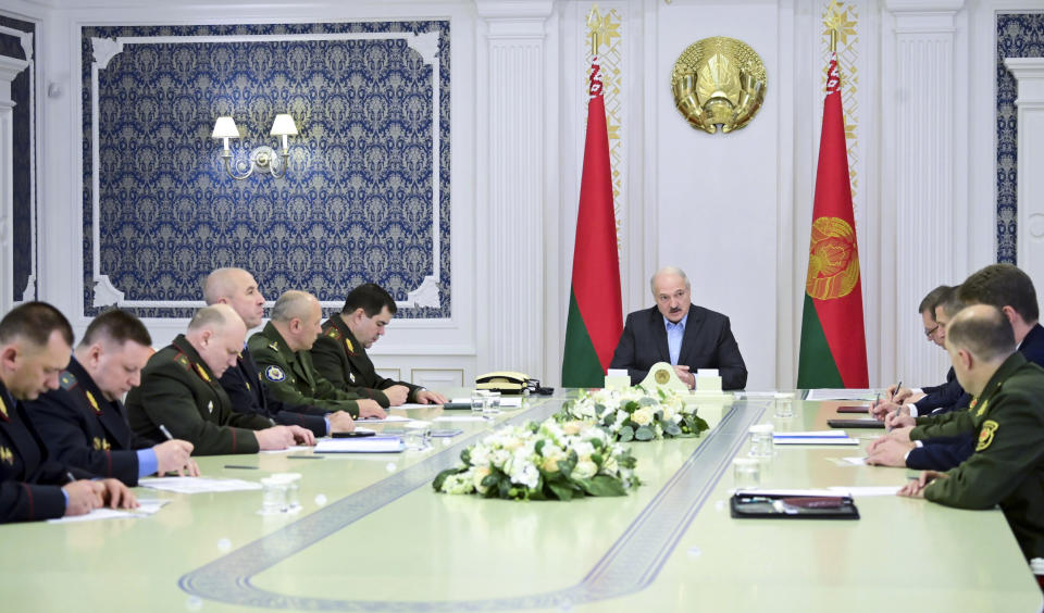 Belarusian President Alexander Lukashenko attends a meeting with top officials of the country's security agencies in Minsk, Belarus, Saturday, Sept. 12, 2020. Throughout the unrest, he has rejected any concessions, has repeatedly accused Belarus' western neighbors of preparing to overthrow his government and has made shows of aggressive defiance, including striding with an automatic rifle across the grounds of his presidential residence. (Andrei Stasevich/BelTA Pool Photo via AP)