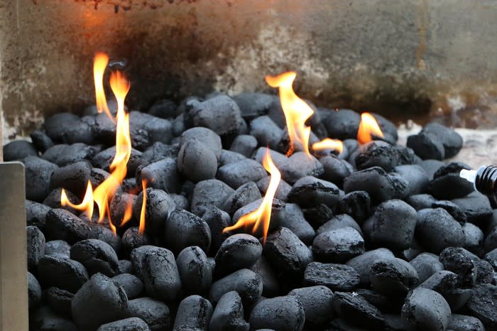 Charcoal burning in an open grill