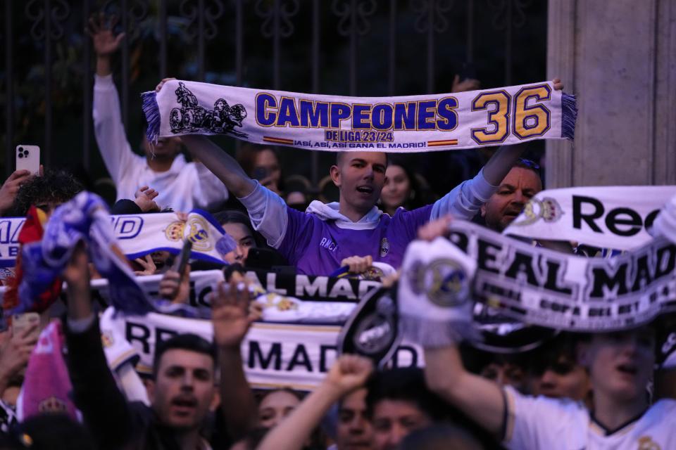 Real Madrid supporters celebrate in Cibeles Square in Madrid after their team clinched the La Liga title, Saturday, May 4, 2024. Real, who had won earlier in the day, clinched the title after Barcelona failed to beat Girona. (AP Photo/Manu Fernandez)