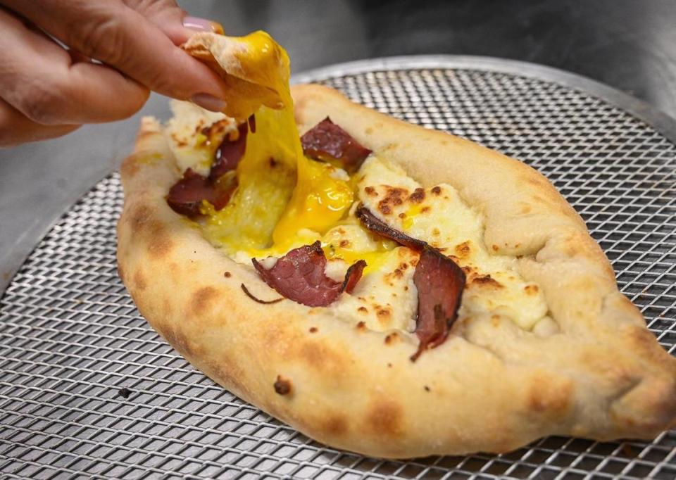 Georgian cheese bread, which has a egg lightly cooked in the center with basturma cured beef pieces and a three-cheese mix, is one of the more popular breakfast meals at Baklava House in Fresno.