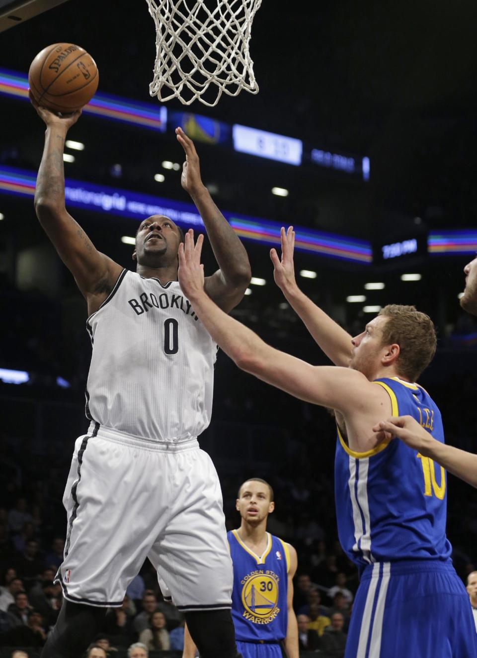 Brooklyn Nets' Andray Blatche (0) shoots over Golden State Warriors' David Lee (10) during the first half of an NBA basketball game Wednesday, Jan. 8, 2014, in New York. (AP Photo/Frank Franklin II)