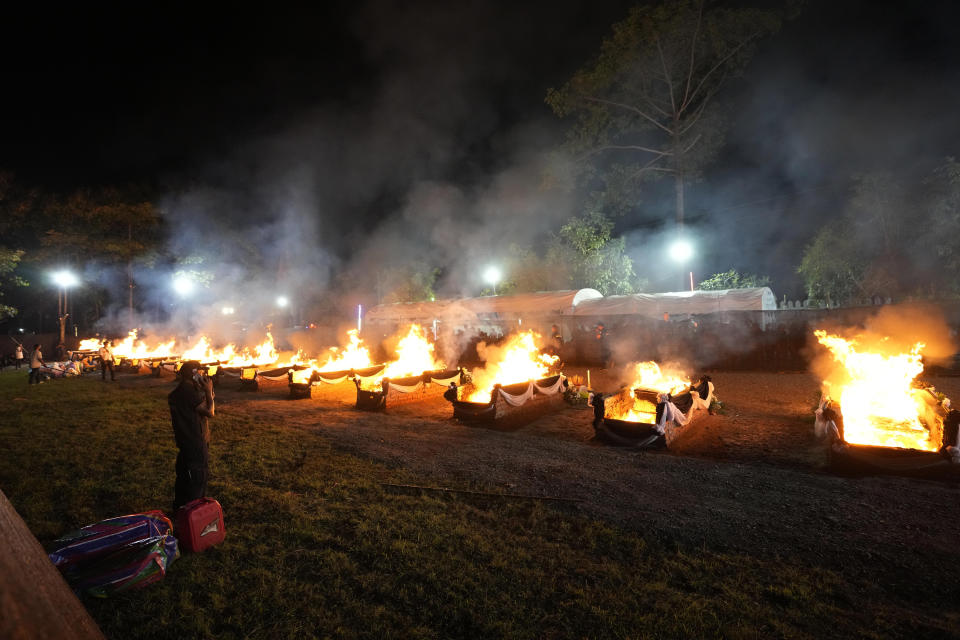 Funeral pyres cremate those who died in the day care center attack at Wat Rat Samakee temple in Uthai Sawan, northeastern Thailand, Tuesday, Oct. 11, 2022. A former police officer burst into a day care center in northeastern Thailand on Thursday, killing dozens of preschoolers and teachers before shooting more people as he fled. (AP Photo/Sakchai Lalit)