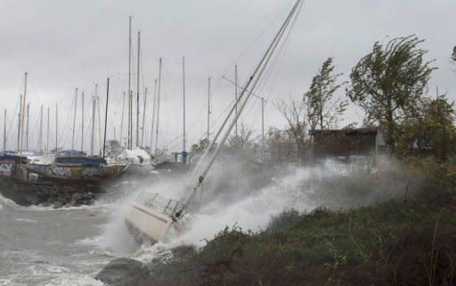 A sailboat smashes on the rocks after breaking free from its mooring on City Island, New York. Hurricane Sandy drove a deadly tidal surge into coastal cities along the eastern US coast Monday and pushed storm-force winds, torrential rain and heavy snow deep inland