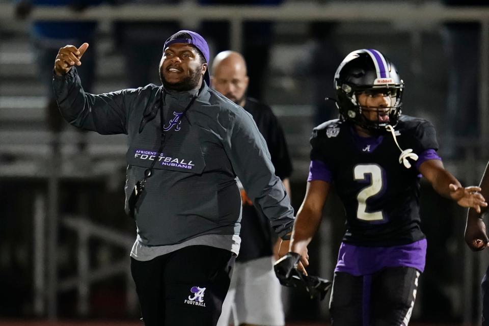 Africentric's Caleb Anthony, seen here with coach Jamell Davis, was named first-team All-Ohio in Division V.