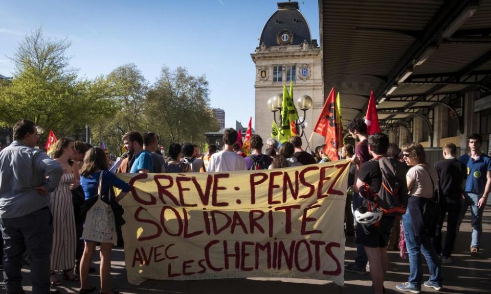 Striking French railway workers hold banners and placards as they gather in front of Matabiau station in Toulouse on 17 April 2018.