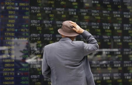 A man looks at a stock quotation board outside a brokerage in Tokyo May 11, 2012. REUTERS/Toru Hanai