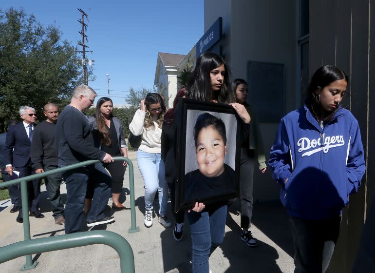 SOUTH GATE. , CALIF. - FEB. 13, 2023. Family members carry a picture of Isaiah Rodriguez, who was killed when the car he was in collided with the vehicle of an off-duty cop. Los Angeles County Sheriff's Deputy Ricardo Castro is accused of speeding in his pickup truck on Nov. 3, 2021, when he T-boned a car turning left at an intersection, killing the 12-year-old boy. ikilling Isaiah Rodriguez . (Luis Sinco / Los Angeles Times)